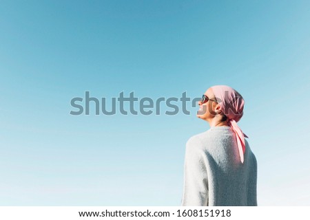 Similar – Image, Stock Photo Woman with pink scarf for cancer looking at the sea in bikini from the beach