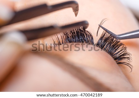 Eyelash Extension Procedure. Woman Eye with Long Eyelashes. Lashes, close up, macro, selective focus. Stockfoto © 