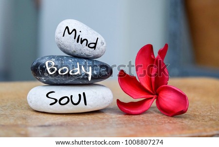 Holistic health concept of zen stones with deep red plumeria flower on blurred background. Text body mind soul. Imagine de stoc © 