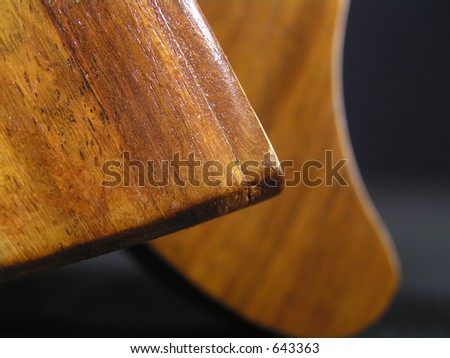 abstract of a wood harp base on a dark background. Shallow depth of field.