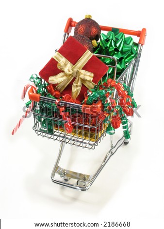 Christmas packages, ornaments candy cane and a bow in a miniature shopping cart.