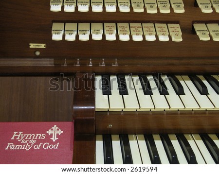 Hymnal resting beside a church organ.