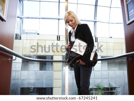Business woman in fancy elevator