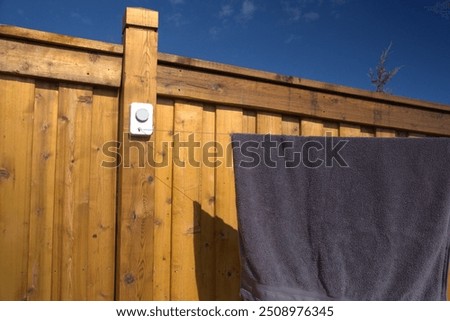 Similar – Image, Stock Photo Towels on clothesline between two trees on the campsite. In the background a caravan with awning.