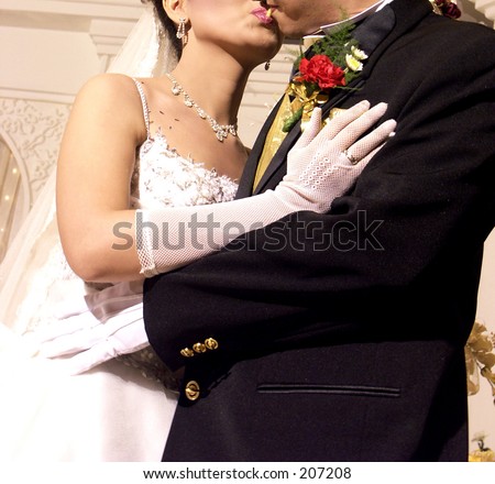 bride and groom sharing piece of cake by their mouths