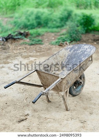 Similar – Image, Stock Photo An old rusty wheelbarrow with a fat black balloon tyre tries to hide in a lilac bush, but doesn’t quite succeed