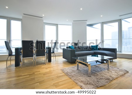Luxurious open plan living room and lounge with large dining table and modern sofa