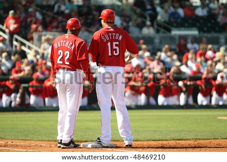 GOODYEAR, AZ - MARCH 5: Rookie Drew Sutton consults with first base coach Billy Hatcher during the Cincinnati Reds\' inaugural Cactus League game March 5, 2010 at Goodyear Ballpark, Goodyear, Arizona.