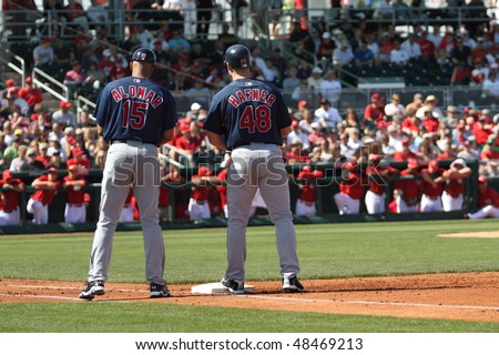 GOODYEAR, AZ - MARCH 5:Travis Hafner consults with first base coach Sandy Alomar during the Cleveland Indians\' Cactus League game vs. the Reds on March 5, 2010 at Goodyear Ballpark, Goodyear, Arizona.