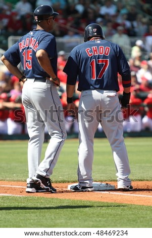 GOODYEAR, AZ - MARCH 5: Shin-Soo Choo consults with first base coach Sandy Alomar during the Cleveland Indians\' Cactus League game vs. the Reds on March 5, 2010 at Goodyear Ballpark, Goodyear, Arizona.