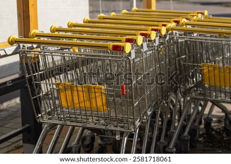 Similar – Image, Stock Photo Shopping carts arranged in the parking and entrance area of a giant warehouse supermarket, on the outskirts of Zaragoza city, Spain.