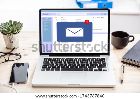 Email notification concept, one new inbox e mail, envelope with incoming message on computer laptop screen, business office desk background