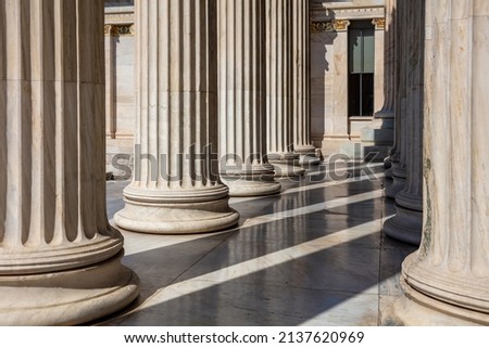 Classic columns pillars white marble. Athens Greece Academy neoclassical building entrance colonnade. Classical pillars in a row. 商業照片 © 