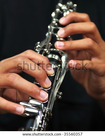 Closeup of a man playing a clarinet