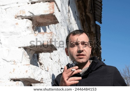 Similar – Image, Stock Photo Young man smoking cigarette in the night