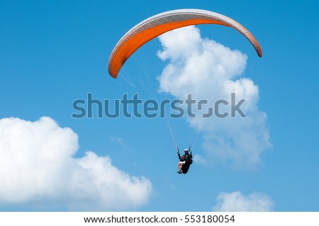 Similar – Image, Stock Photo paragliding man with orange paraglider against the sun