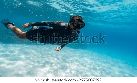Image, Stock Photo Young man with snorkel and diving mask swimming and taking a selfie under water. Travel, vacation and sports activity concept.