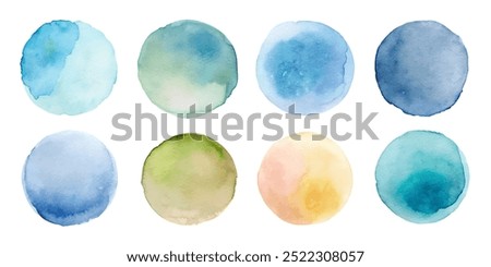 A set of watercolor circles in various shades of blue and green. The circles are arranged in a grid, with some overlapping and others standing alone. Scene is calm and serene, with the colors