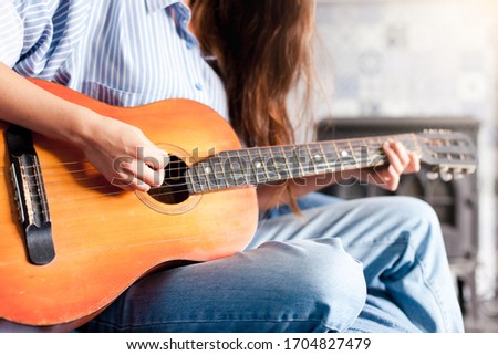 Similar – Image, Stock Photo Calm woman playing guitar in bedroom