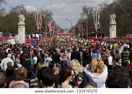 LONDON, UK - APRIL 21: The Finish Line of London Marathon just opposite Buckingham Palace with runners approaching the end of the marathon on April 21, 2013 in London, UK.