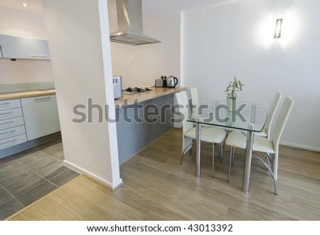 modern open plan kitchen with separate work zones and dining table