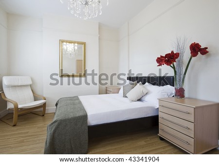 luxury bedroom with modern furniture and flowers