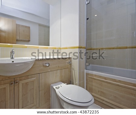modern bathroom detail with hard wood elements and floor to ceiling tiles