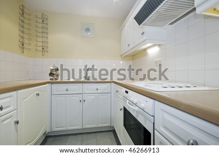classic kitchen with white appliances and yellow wall paint