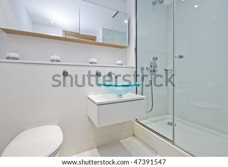 luxury designer en-suite bathroom with shower cabin and glass bowl hand wash basin
