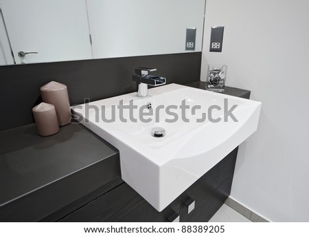 minimal style designer bathroom with rectangular hand wash and waterfall style tap