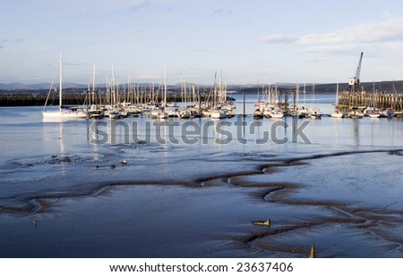 Tide\'s out.  Mud flats showing at Port Edgar at the mouth of the Firth of Forth, Scotland.