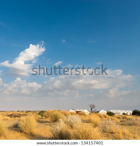 Tent camping site hotel for tourist  in the thar desert under blue sky
