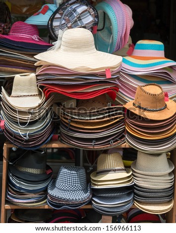 Varied fashion hats showcase on open market shop