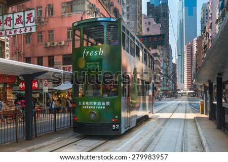 HONG KONG, CHINA - 18 JAN 2015: Electric trolleys and motor vehicles on a typical downtown street in Hong Kong, China.