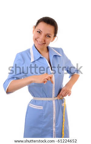 Young woman in blue uniform shows how her waist is thin. Isolated on white background.