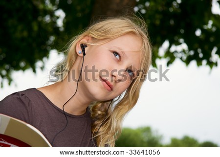 a girl with earphones look thoughtfully
