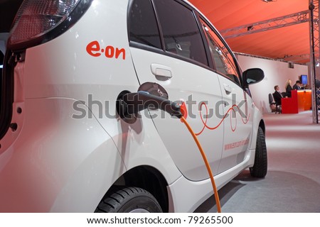 ESSEN, GERMANY - MAY, 5: An electric-car is charged at an E.ON-energy-service-station, shown on the General Meeting of Shareholders, May 5, 2011 in Essen, Germany