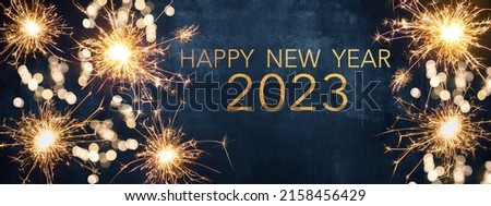 Photo of HAPPY NEW YEAR 2023, New Year's Eve Party background greeting card  - Sparklers and bokeh lights, on dark blue night sky