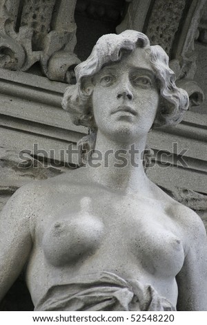 topless woman sculpture on building, Trieste, Italy