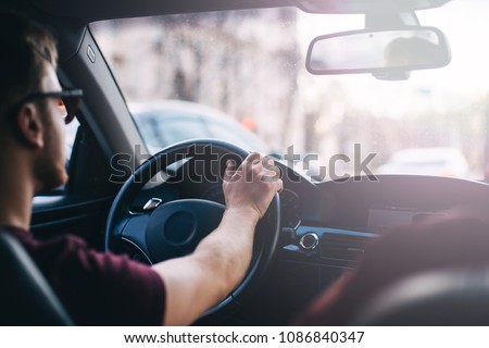 young man driving a business car. trip of a businessman in sunny weather. Stock foto © 