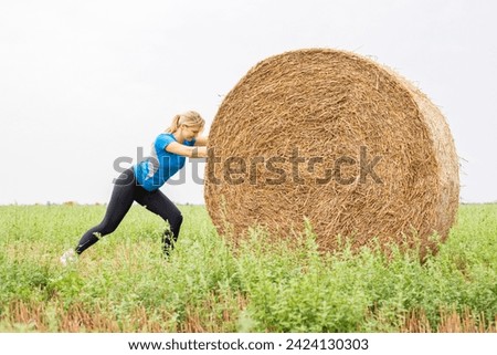 Similar – Image, Stock Photo Woman Pushing Hay Bale