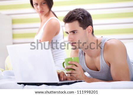Young angry woman and man working on laptop