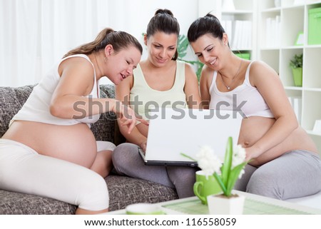 Three pregnant women watching something interesting over internet