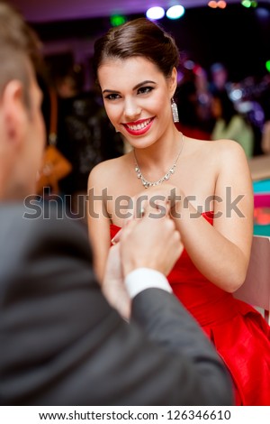 Man proposing girl, excited young woman looking at him