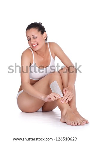 Beautiful woman doing depilation with waxing, expressing pain on face