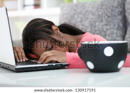 Tired student sleeping on laptop