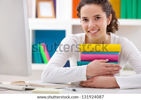 cheerful student girl hugging books, she love school