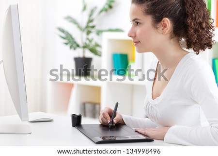 Young graphic designer working on graphic tablet