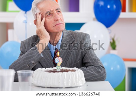 Senior men sitting front of cake birthday ask yourself how old am I