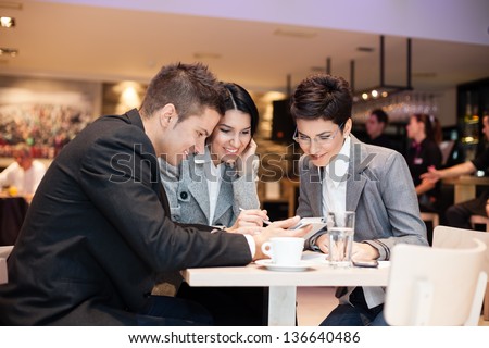 businesspeople having leisure time together in  cafe